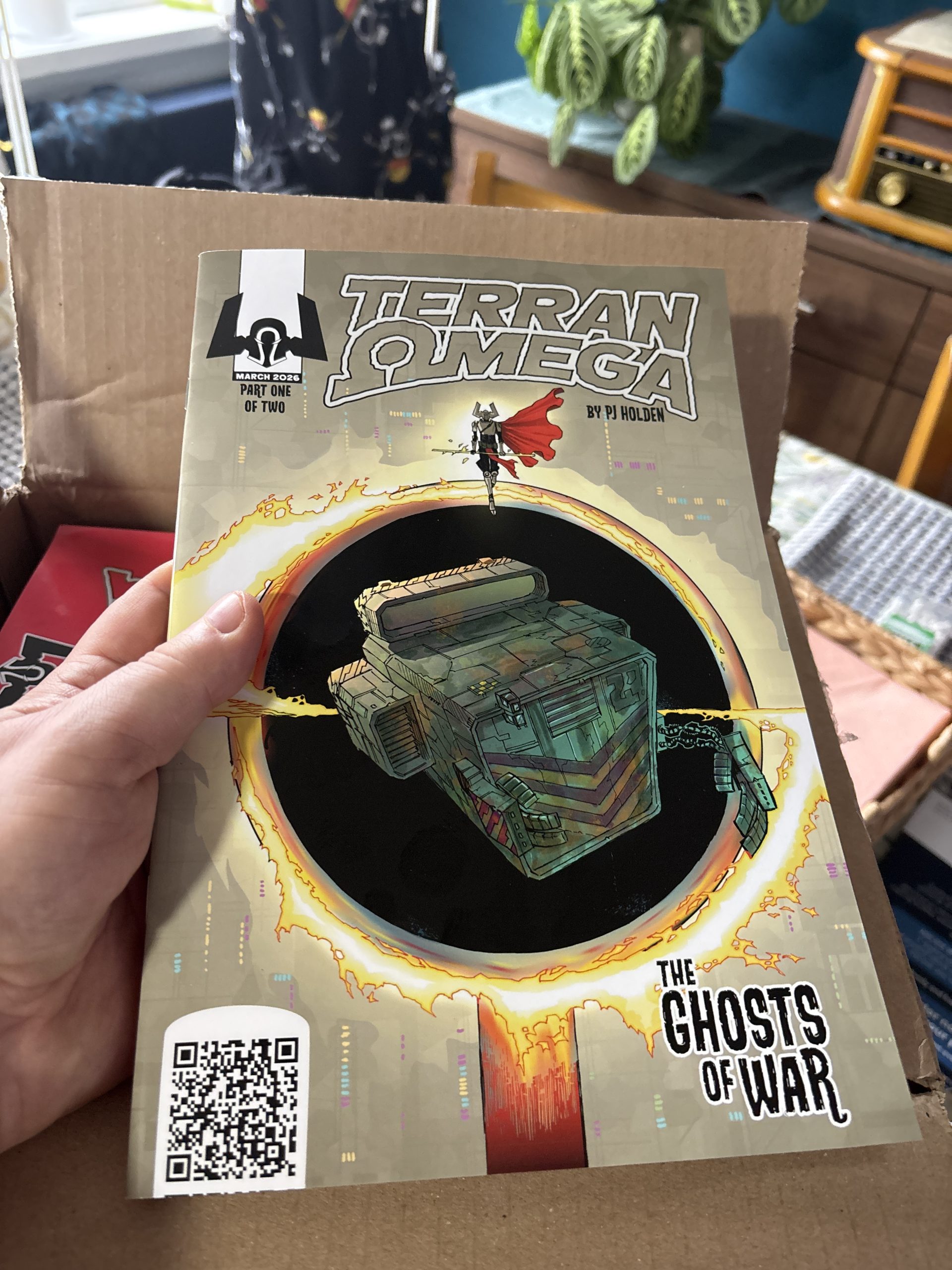 Me holding a print copy of Terran Omega